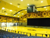 ::auditorium/basketball court of course decorated with corn murals::